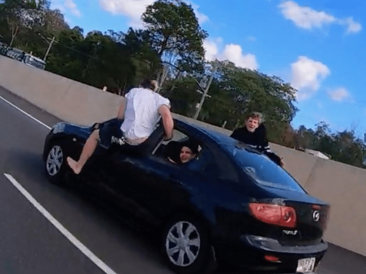 Motorcyclist Captures Outrageous High-Fiving Incident on Queensland Highway